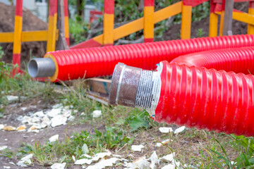 The red pipe is prepared for the replacement of the water supply. Replacement of the city pipeline.