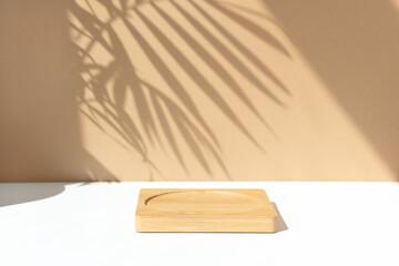 Minimal abstract background for the presentation of a cosmetic product. Wooden scene on a white table. Premium podium with a shadow of tropical palm leaves on a beige wall. Showcase, display case.