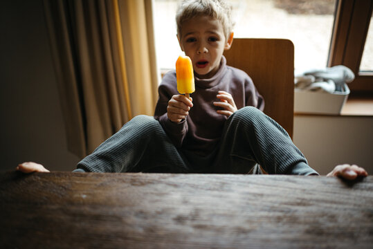 Boy eating an ice cold popsicle