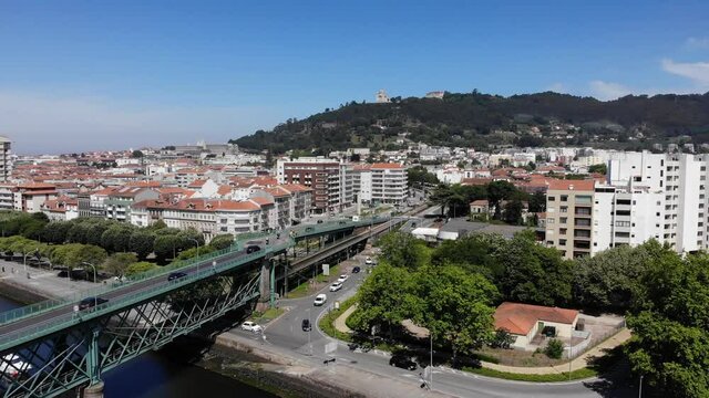 Viana do Castelo, Portugal - June 10, 2021: DRONE AERIAL FOOTAGE - Gustave Eiffel Bridge over the river Lima in Viana do Castelo. Aerial panoramic cityscape view of Viana and the Marina.