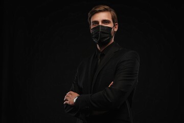 Business Concept - Portrait Handsome Businessman in protective face mask on black background
