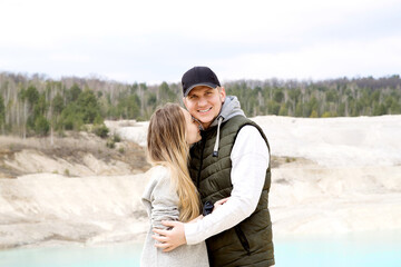 Happy beautiful couple on the background of blue lake