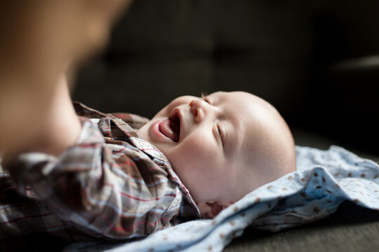 Closeup of laughing baby laying down