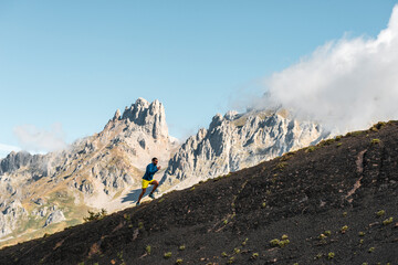 Animated sportsman runnig uphill in mountain range 