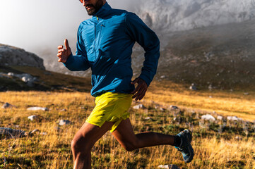 Crop of athlete doing sports training against fog