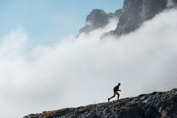 Adult male athlete doing sports training against fog