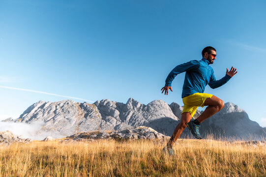 Sporty male working out sprint in highlands
