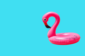 inflatable circle or ring for kids pink flamingo for floating in summer vacation isolated on colored background
