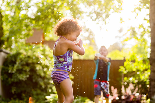  Girl sprayed in water fight with brother