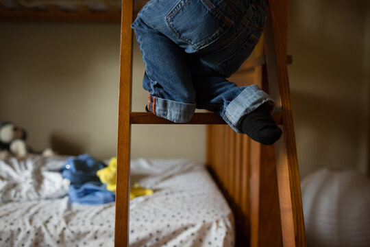 Small Child's feet climbing bunkbed ladder