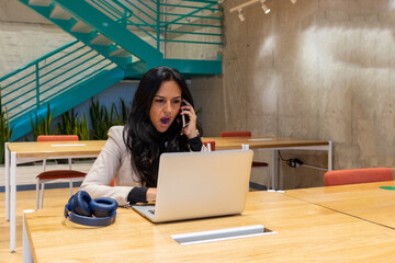 Brunette woman working from her workspace