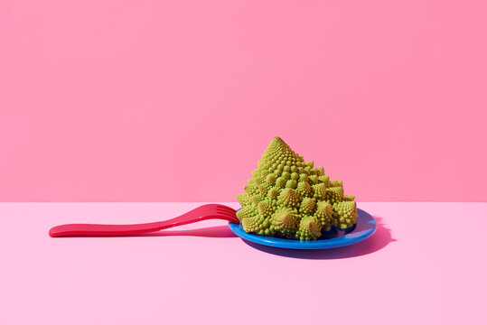 baby romanesco broccoli in a blue plate and fork