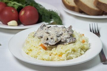 Pilaf with mushroom gravy in a creamy sauce. Delicious and healthy food. Vegetarian dish.