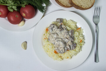 Pilaf with mushroom gravy in a creamy sauce. Delicious and healthy food. Vegetarian dish.