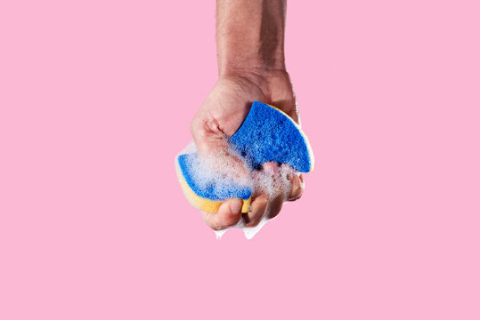 squeezing a foamy kitchen sponge