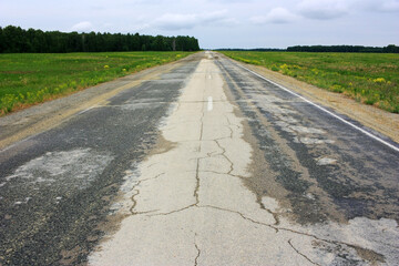 Asphalt empty road in the green field