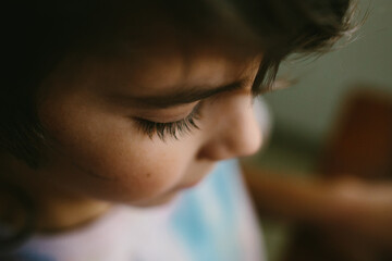 Profile view of a young boy with long eyelashes