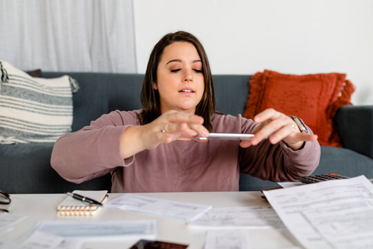 Woman Scans a Document to Upload to an Online Tax Preparation App