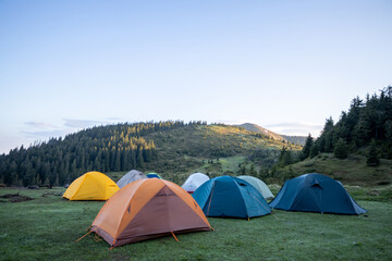 Hiking tents in the mountains set outdoor. Colorful trekking tents outsige
