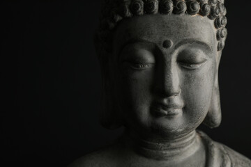 Beautiful stone Buddha sculpture on black background, closeup. Space for text - Powered by Adobe