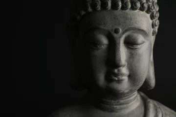 Rolgordijnen Beautiful stone Buddha sculpture on black background, closeup. Space for text © New Africa