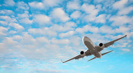 White passenger plane soaring towards low clouds - Travel by air transport