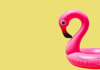 inflatable circle or ring for kids pink flamingo for floating in summer vacation isolated on colored background