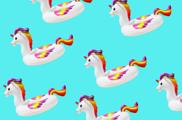 Obraz premium inflatable circle or ring for kids rainbow unicorn for floating in summer vacation isolated on blue background, inflatable toy pattern