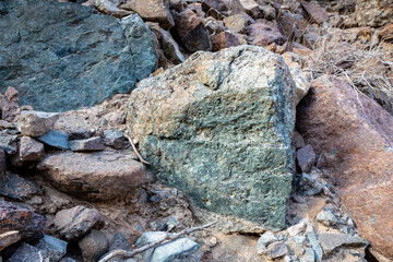 Raw ore of copper, green stones and rocks containing copper in old mining area, Hajar Mountains,...
