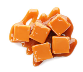 Heap of sweet caramel candies with topping isolated on white, top view