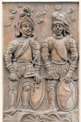 Fototapeta na wymiar Relief of knights on the wall of a house in Kutna Hora - house sign