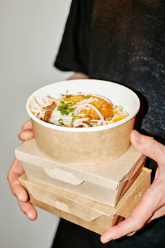 A man holds delivered food 