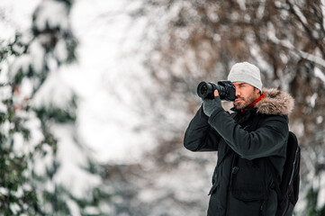 Man taking photos in winter park