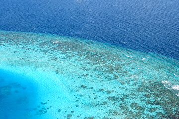 Overlooking the beautiful blue coral atoll of the Maldives in the Indian Ocean