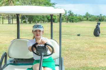 Female athlete driving a golf cart in competition