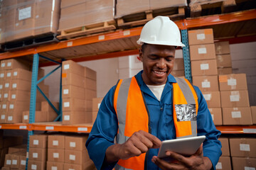 Portrait of a warehouse manager keeping stock records using digital tablet - Powered by Adobe