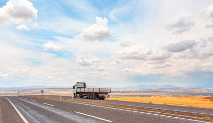Fototapeta na wymiar Truck on the asphalt road while keep moving - Commercial cargo delivery truck