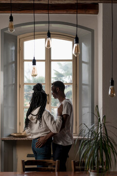 Pensive Black Couple looking out of the window