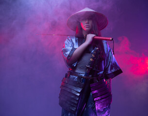 Woman samurai with bamboo hat and steel katana