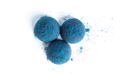 Blue, chocolate candy truffles isolated on a white background.