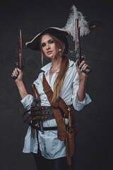 Woman corsair wearing shirt and hat with guns