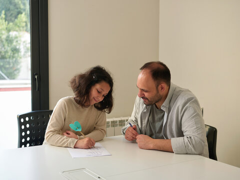 Charming girl studying with father