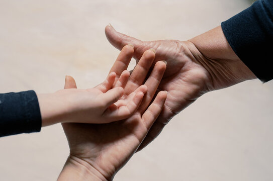 intergenerational women's hands- grandmother, daughter, granddaughter palm up