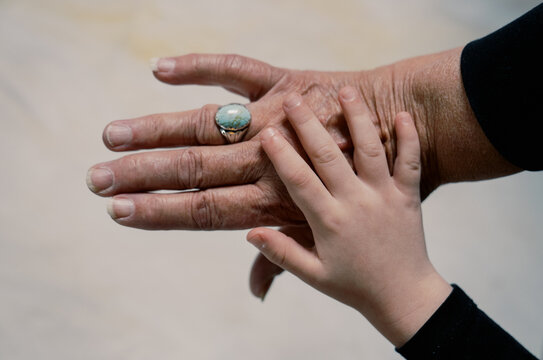 intergenerational women's hands- grandmother and granddaughter