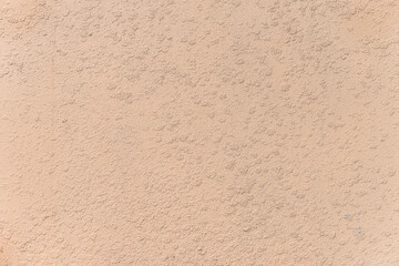Texture of pastel peach colour concrete wall, Stucco Wall close-up.