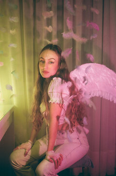 Woman with angel costume and feathers floating around