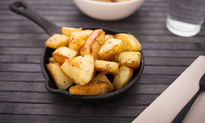 golden fried potatoes on small cast iron skillet