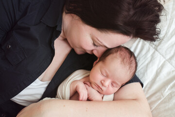 Mother snuggling with her newborn baby