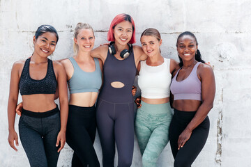 Cheerful multiracial sporty women looking at camera