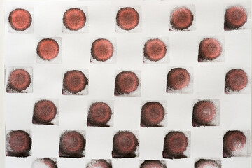 abstract background composition with reddish-black (brown) ink pad stamped loosely arranged on light background - photographed from above in a flat lay style
